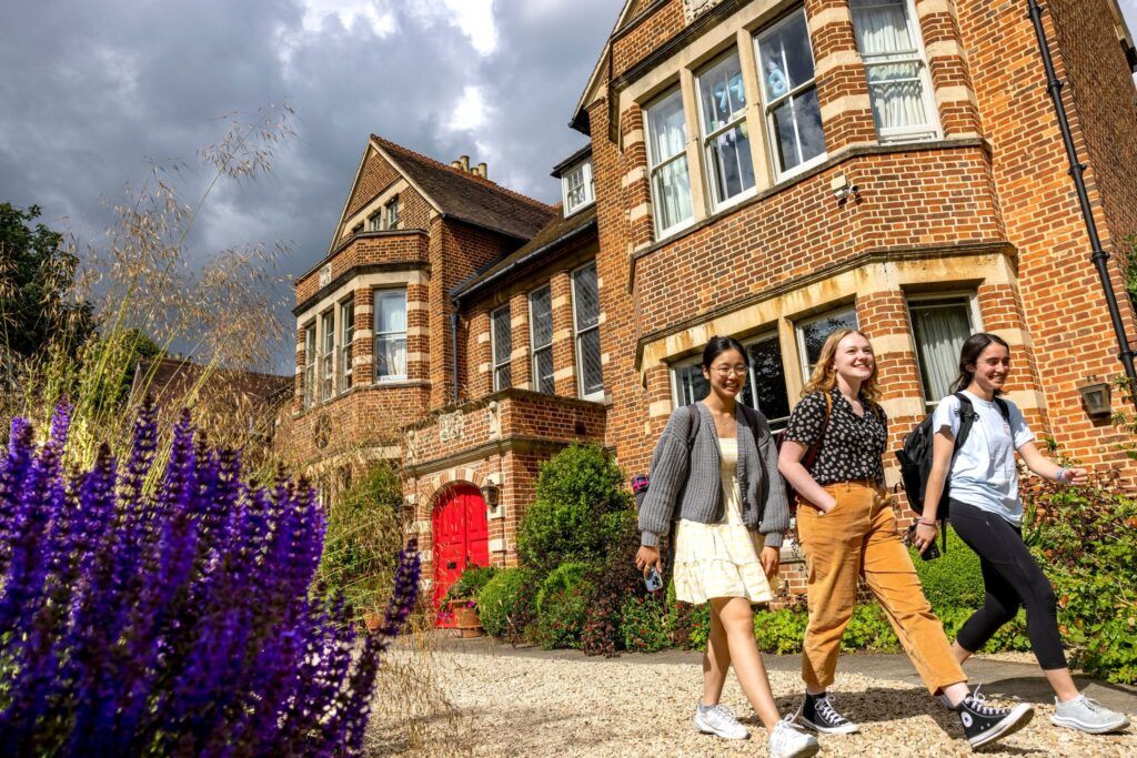 Three female students walk away from the UGA at Oxford Centre.