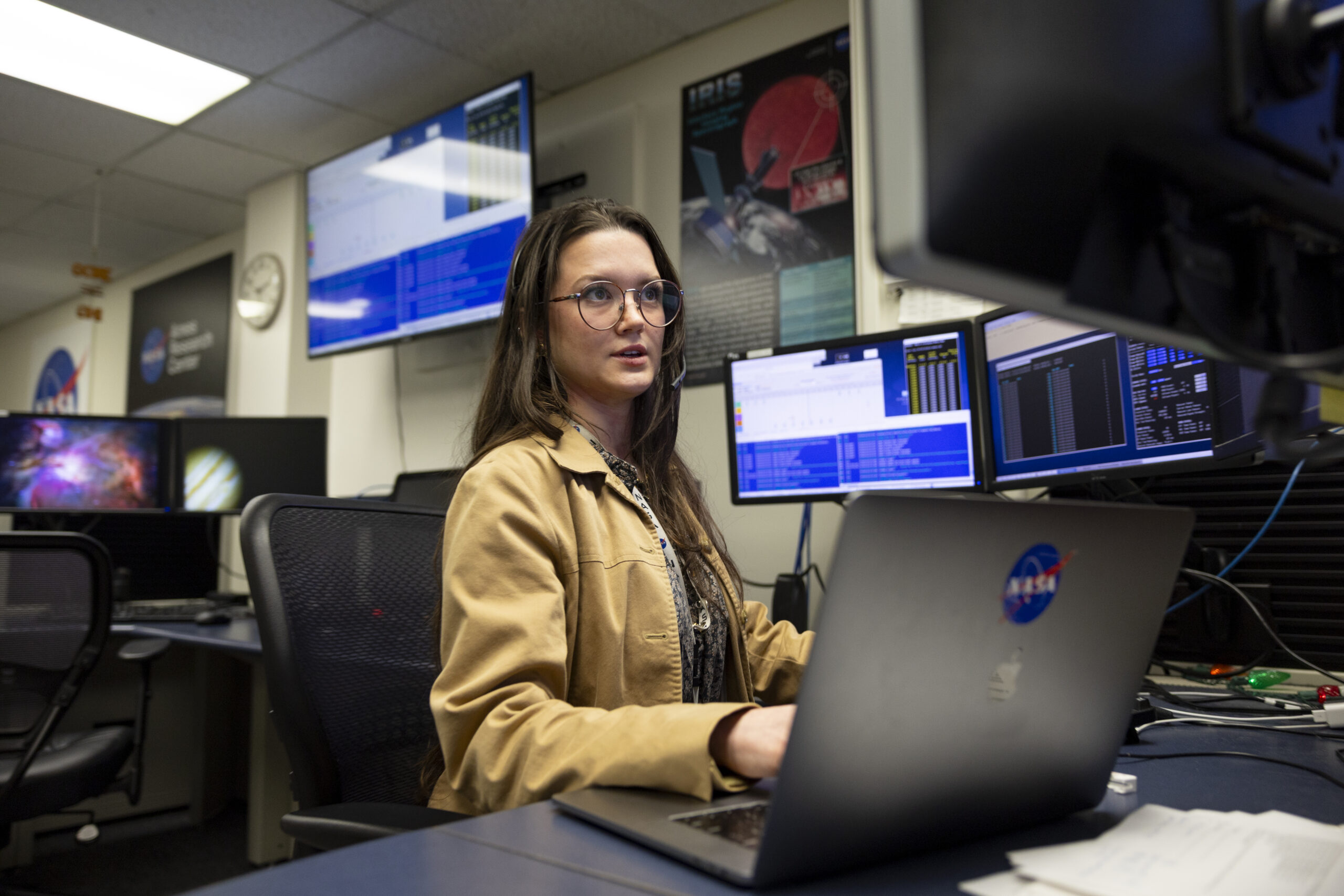 A woman types on a computer in a computer lab.